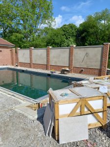sand and cement render to panels side of the pool